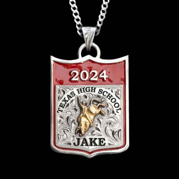 " Rodeo mamas, get this necklace for your rodeo kid and they'll never take it off. Crafted on a German Silver base with hand-engraved scrollwork. Detailed with our signature red enamel and a rodeo figure of your choice. Scroll down to customize your 